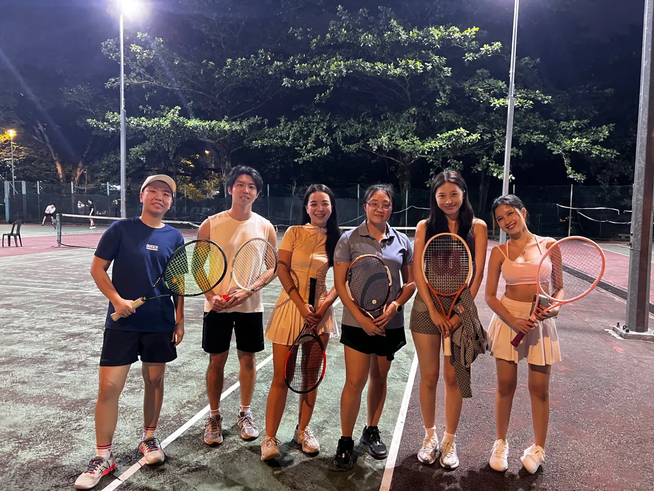 Players at a beginner and intermediate tennis clinic