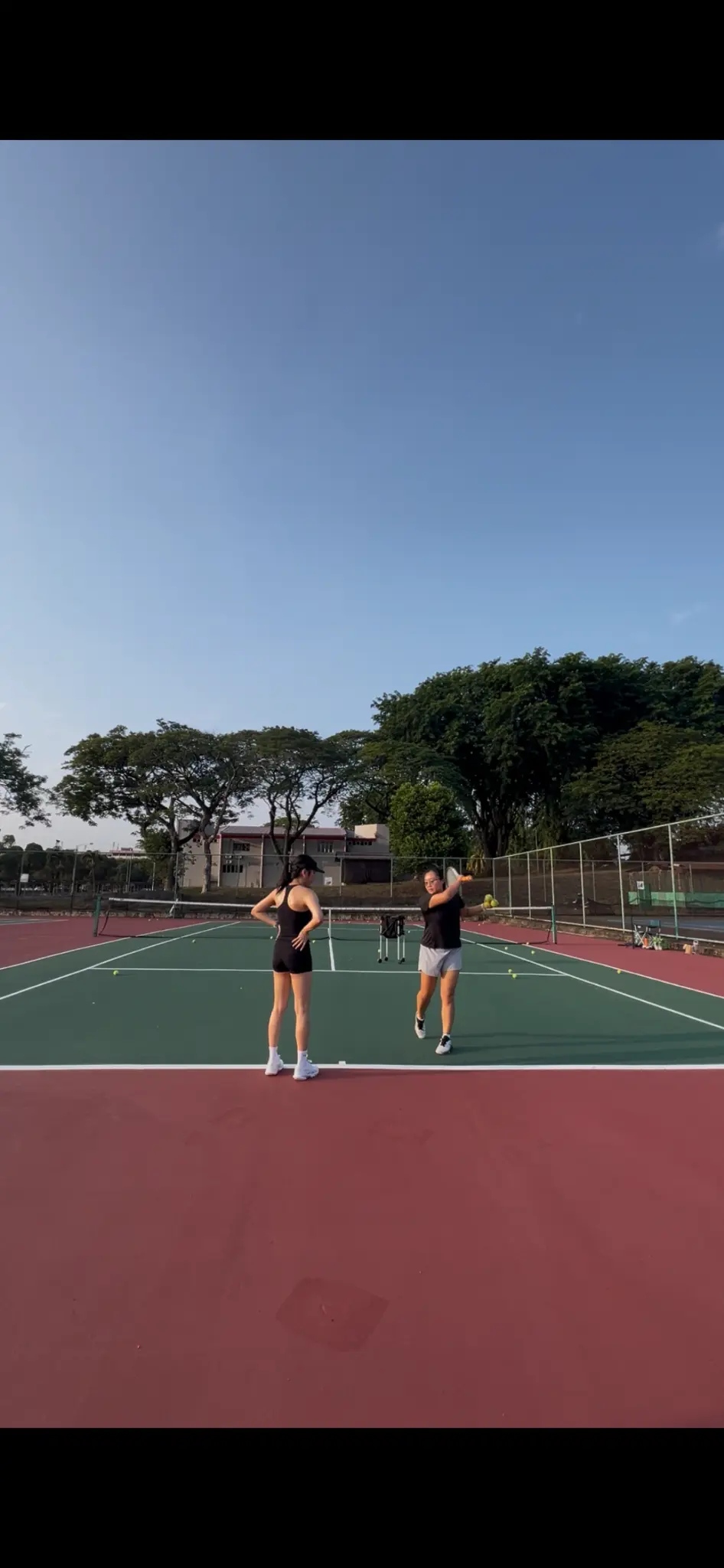 Tennis coaching drill with players on court