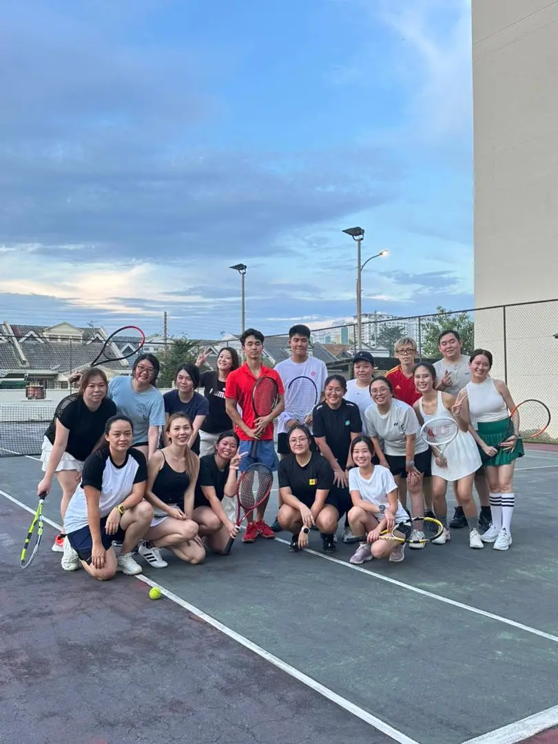 Coach Bei with a tennis community group